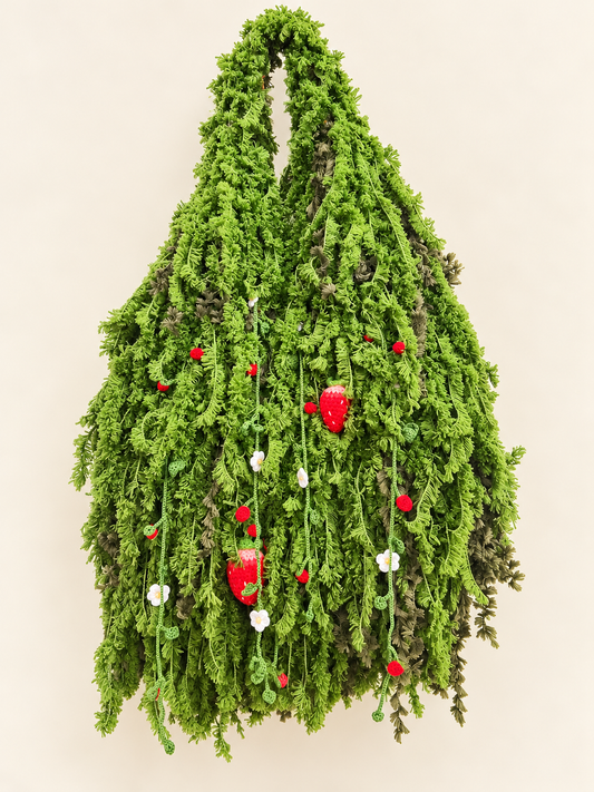Handmade Strawberry Moss crochet foraging bag with cascading green moss texture, crochet strawberries and white flowers, shown on a warm ivory background